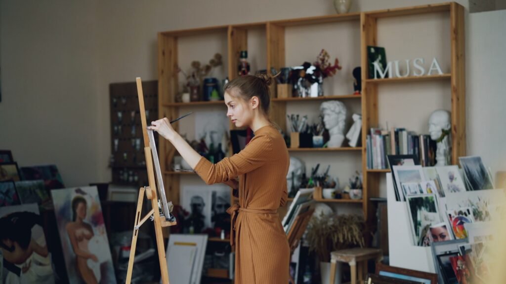 A woman paints in her artistic studio.
